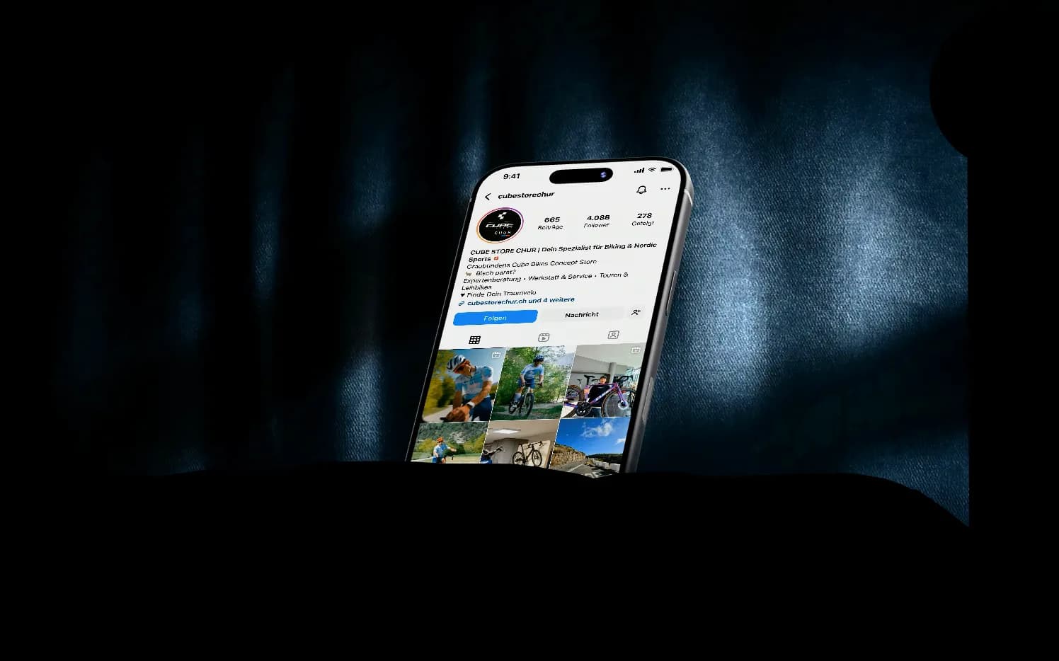 Ein iPhone auf dunklem Stoff zeigt das Instagram-Profil des CUBE Store Chur: erst das Profil, dann das gescrollte Beitragsraster, dann laufende Reels.