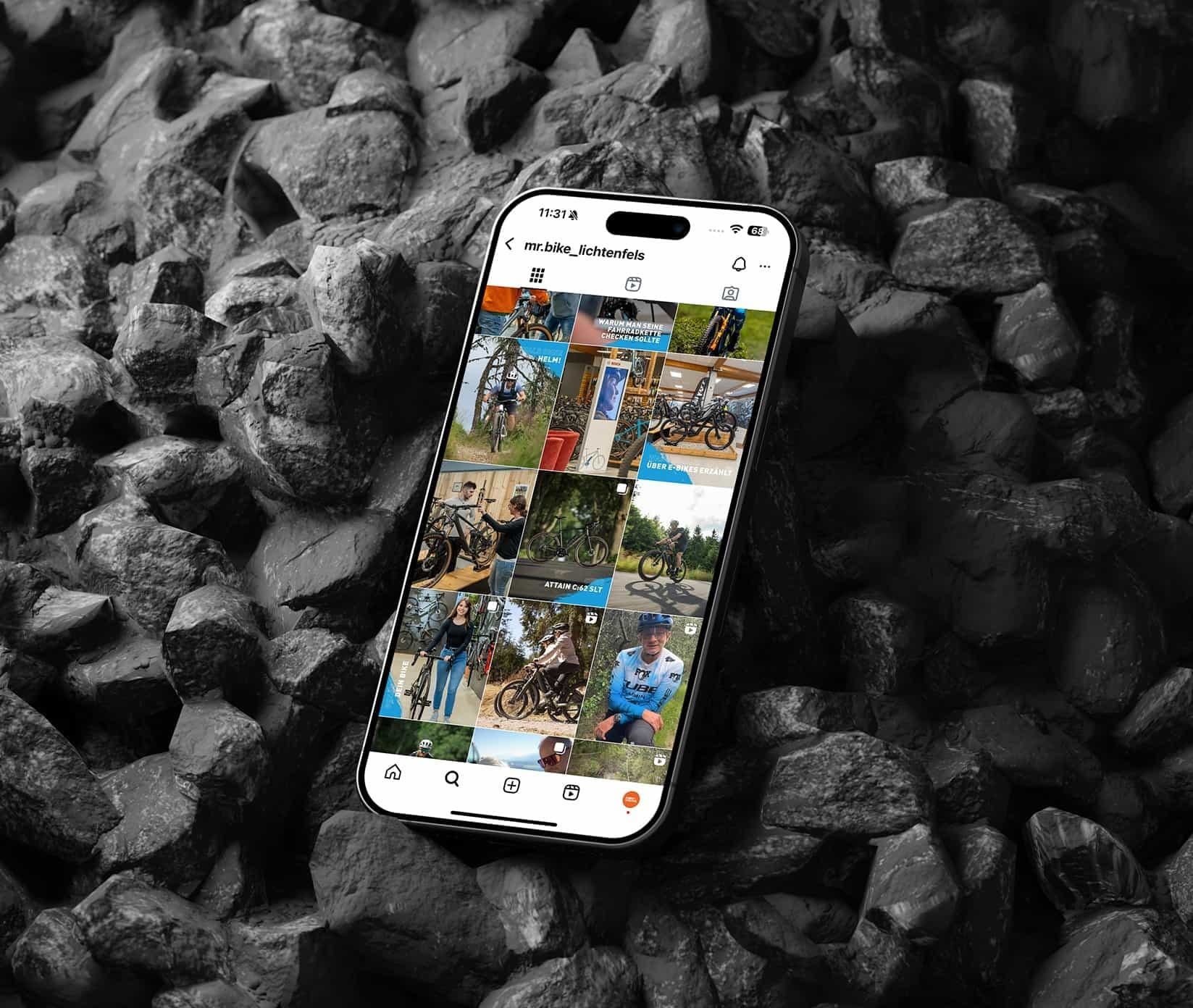 Ein Smartphone auf dunklen Steinen zeigt das Instagram-Profil von mr.bike_lichtenfels: ein Raster aus Bikes, Trails und Beiträgen im Corporate Design.